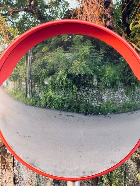 istock Curved Road Reflection in a Red Traffic Mirror 2198621684