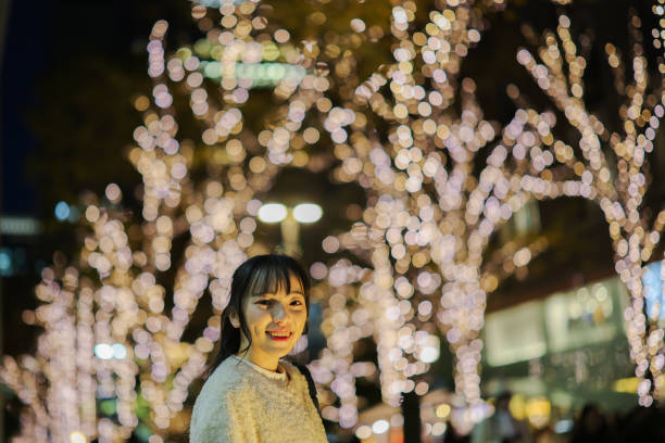 istock Young woman at illuminated street 2198623106