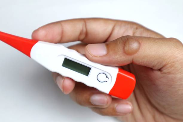 istock Hand holding digital medical thermometer on white background 2198623182