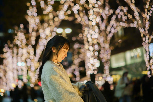 istock Young woman at illuminated street 2198623293