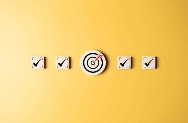 istock Target strategy, Task list, Checklist, Quality Control, Survey assessment to reach goals achievements in business success. To do lists for achieving target. Check mark and dartboard on wooden blocks. 2198624591