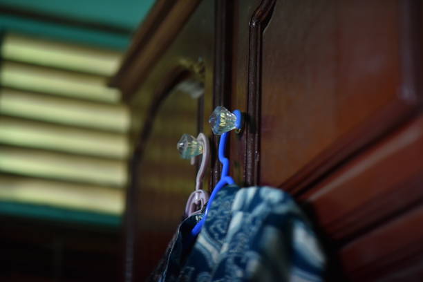 There are types of clothes hooks on the wall and hanging