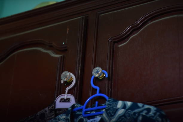 There are types of clothes hooks on the wall and hanging