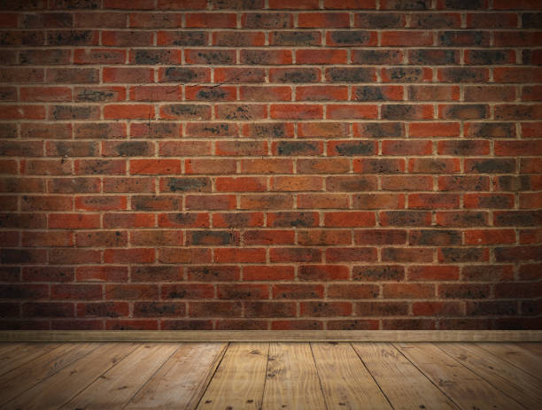 istock Old bricks wall and wooden floor background with vignette effect. 2198626090