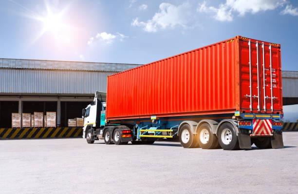 istock Container Trucks Loading at Warehouse Dock. Bulk of Package Boxes to be Loaded into Shipping Containers. Distribution Warehouse. Supply Chain, Shipment. Freight Truck Logistics Transportation. 2198626221