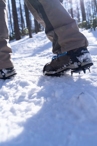 istock Crampons on feet climbing a snowy mountain 2198627500