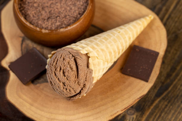 istock chocolate ice cream in a cone on a board 2198628090
