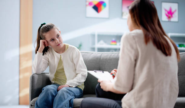 istock young psychiatrist comforts a sad ADHD child during 2198632504