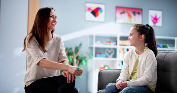 istock Young Child Therapist Comforts Depressed Kid During Counseling Session 2198632510