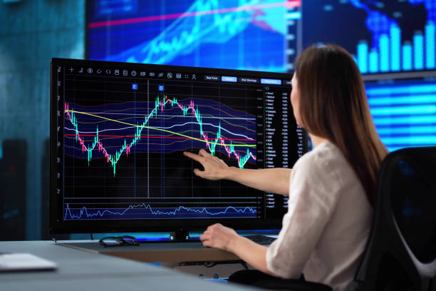 istock Focused businesswoman analyzes stock market data 2198632511