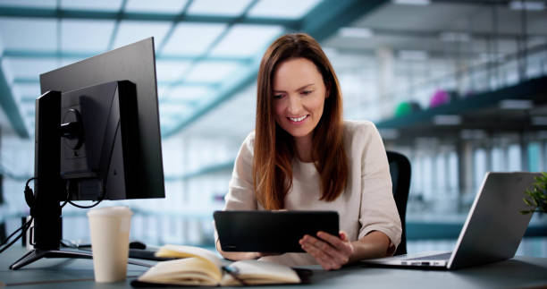istock Young Indian woman analyzes market trends using tablet 2198633713