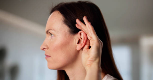 istock Audiologist aids woman with hearing damage 2198633983