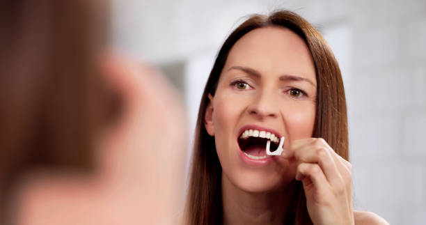 istock Professional Woman Practicing Dental Hygiene With Floss, Plunger 2198634009