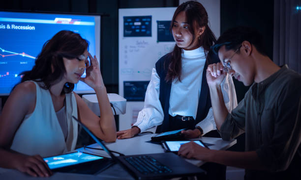 istock team of finance  get stress when analyzing economic crisis data and recession impacts during a late-night meeting in a office 2198634720