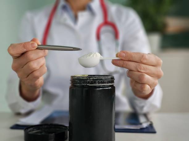 istock Healthcare professional prepares a supplement dose using a measuring spoon 2198636122