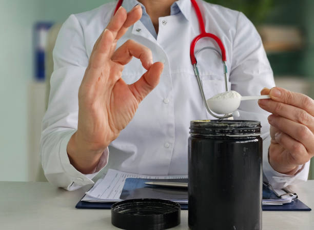 istock Doctor advising on medication dosage while holding a spoon and a jar 2198636126