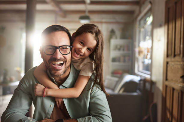 istock Happy daughter embracing her single father at home. 2198636143
