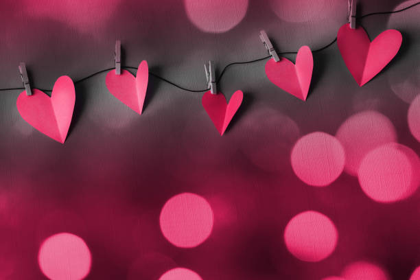 istock Paper hearts on a clothesline with bokeh lights and space for copy 2198636778