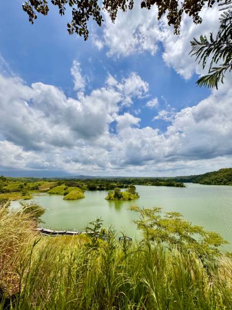 istock Wide-Angle View of Bajulmati Dam with Green Islands and Dramatic Sky in East Java, Indonesia 2198637544