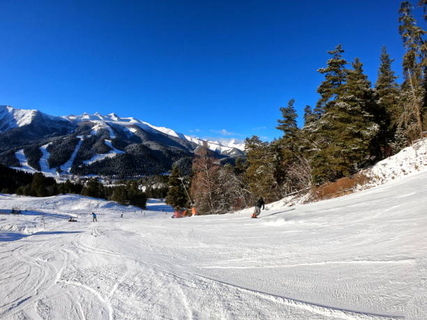 Arkhyz. Russia. January 06, 2025. Ski slopes on a sunny winter day. Descent participants on the route