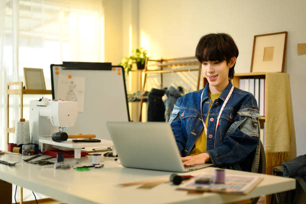 istock Fashion designer working on laptop in a creative studio 2198639600