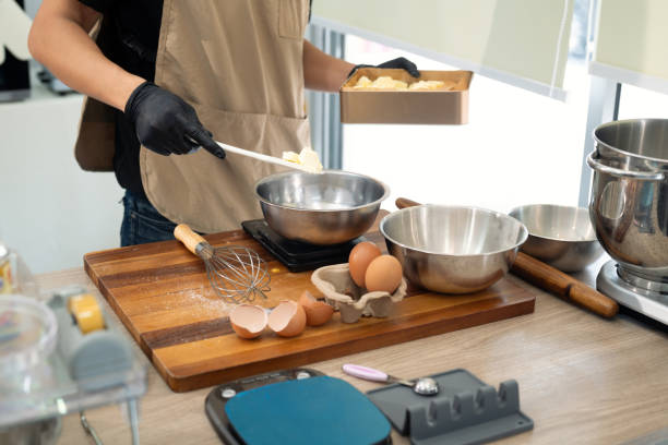 istock Young man measuring ingredients for cookie dough on kitchen counter 2198639617