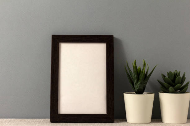 istock An empty photo frame on the table. Mini pots with succulents. A minimalist-style workspace. A place to copy. 2198639830