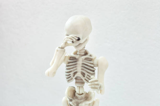 istock Human skeleton covers his face with his hand, shy and shame concept 2198642828
