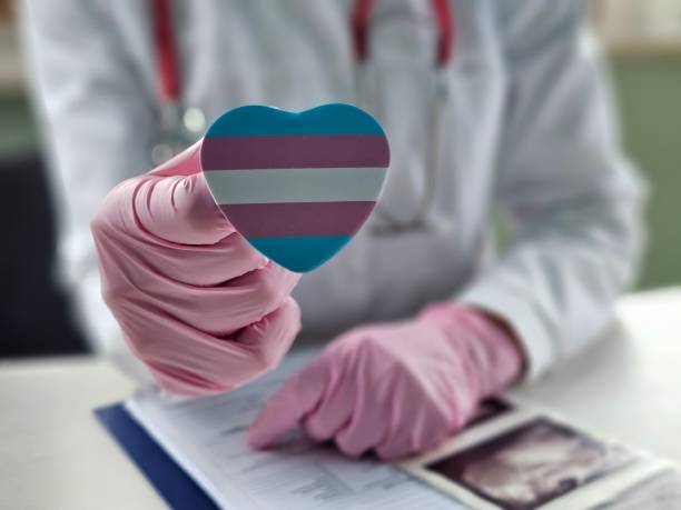 istock Healthcare professional holding a heart-shaped trans transgender pride symbol while discussing patient 2198643285