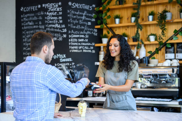 istock Young man paying with phone in cafe 2198643971