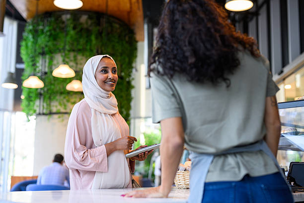 istock Two female entrepreneurs working together in a cafe 2198643979