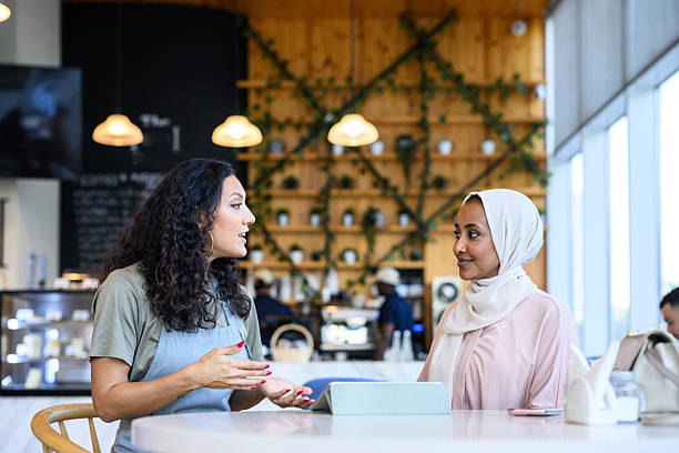 istock Collaborative female entrepreneurs having a discussion in a coffee shop 2198644023