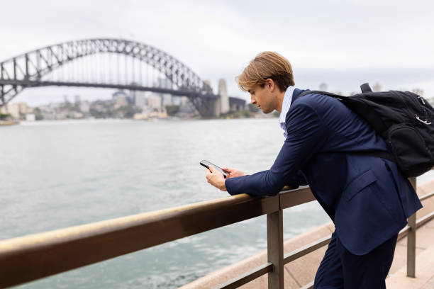 istock Business Professional Using Smartphone Near Sydney Harbour Bridge 2198645285