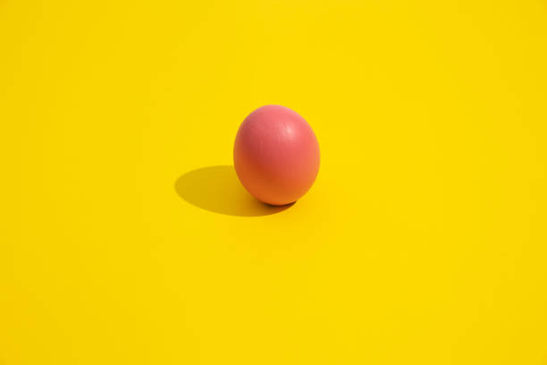 istock Minimalist image of a pink egg on a yellow background 2198645383