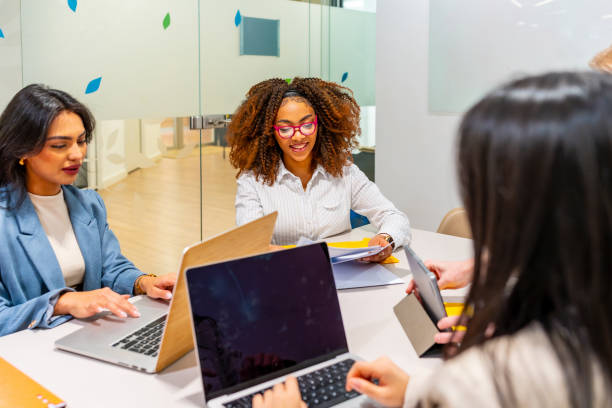 istock Four businesswomen collaborating on project in coworking office space 2198645932