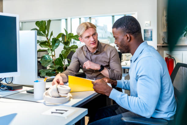 istock Two businessmen collaborating on a project in coworking space 2198645989