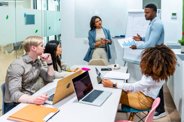 istock Diverse business team analyzing charts in coworking office meeting 2198646016