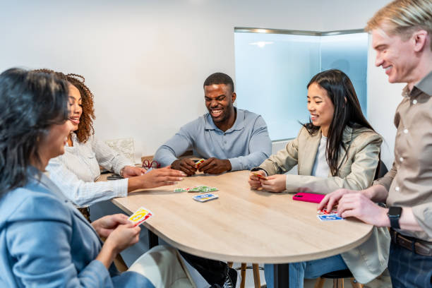 istock Coworkers playing cards in the office during break time 2198646273