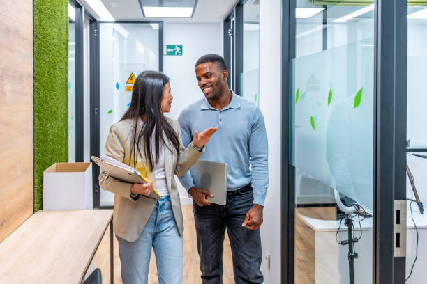 istock Businesspeople walking and talking in modern coworking office 2198646411