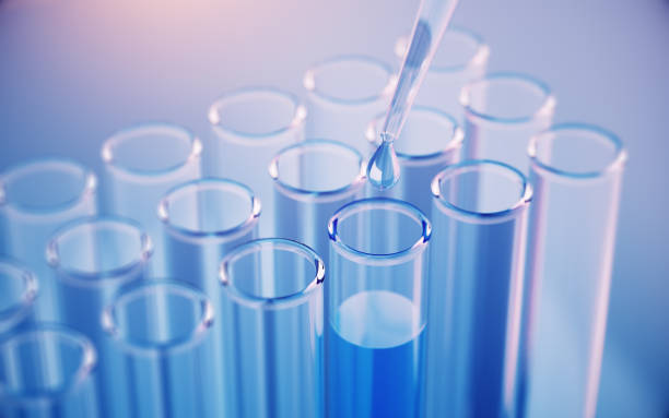 istock Testing Liquid from Glass Pipette to Test Tubes on Blue Reflective Background 2198646660