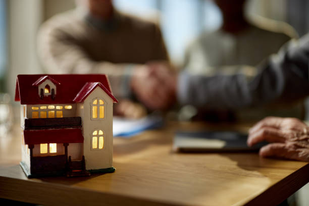 istock Model house during a meeting with real estate agent. 2198646977