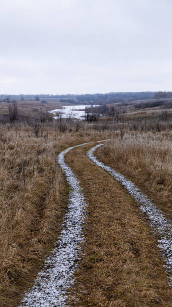 istock A winding path meanders through the vast dried grasslands alongside a gentle rivers edge 2198647344