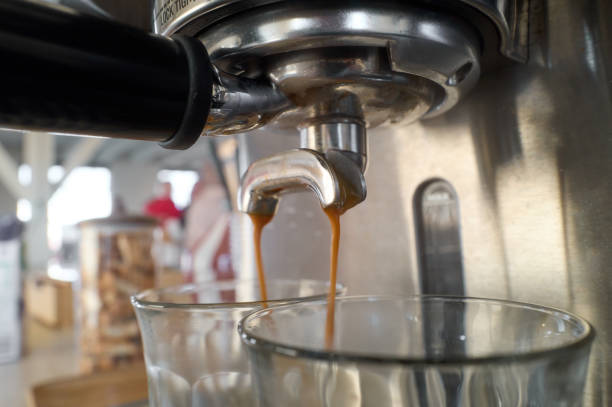 istock Espresso machine pouring coffee into two glasses 2198648119