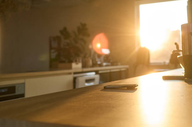 istock Smartphone laying on kitchen counter in morning sunlight 2198648339