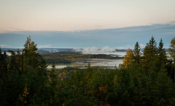 istock Morning mist over autumn forested valley with distant lakes and rolling hills under soft pastel sky 2198648885