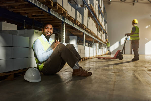istock Cheerful black manager resting on a break in distribution warehouse. 2198648891
