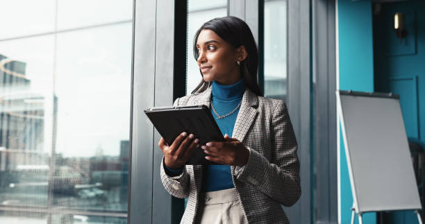 istock Thinking, tablet and window with business woman in office for workshop coordinator, reflection and corporate trainer. Vision, planning and conference organizer with person in agency for schedule 2198649619