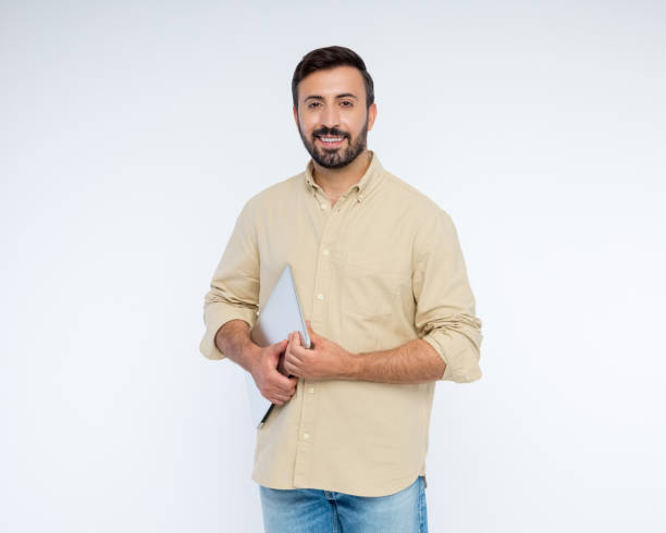 istock Portrait of handsome man holding laptop 2198649929