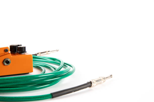 Guitar pedal and cable, music production concept, isolated on white background copy space. High quality photo