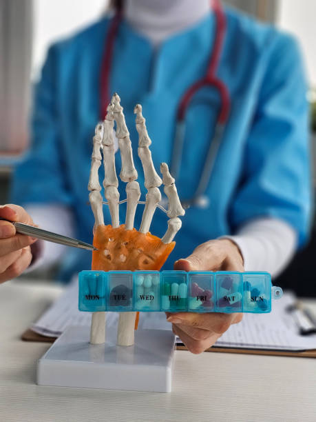 istock Hand anatomy model used for medical education with weekly pill organizer displayed by healthcare 2198652378